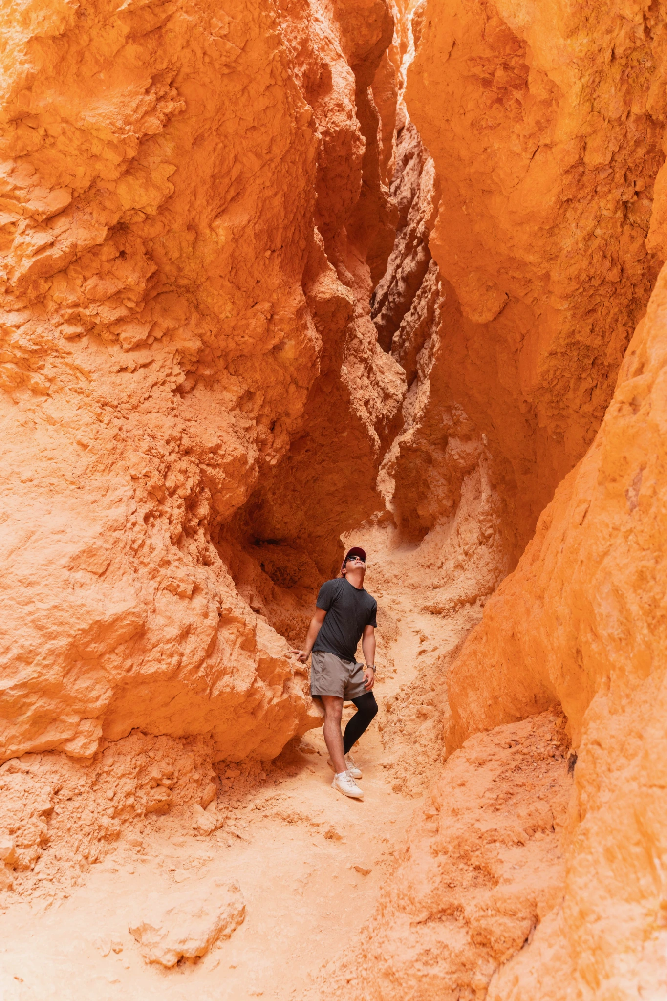 Alex Zacney standing in a narrow slot canyon.